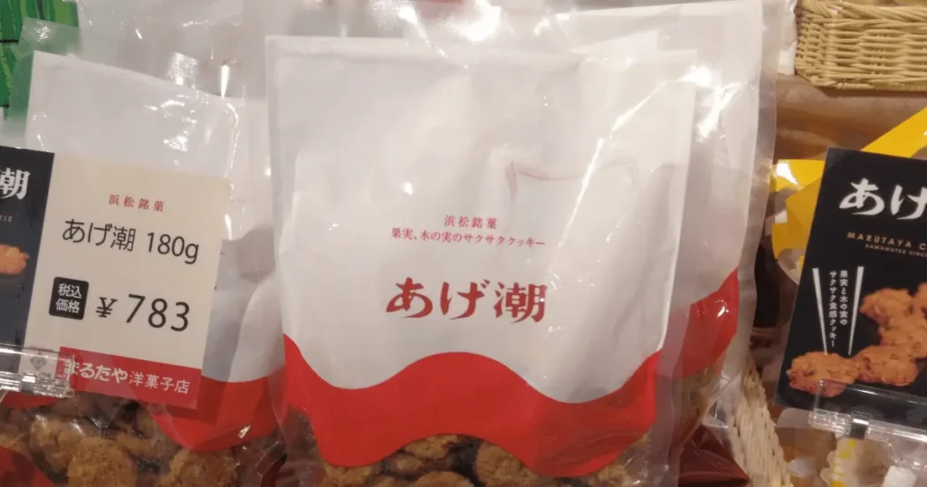 日本百貨店しょくひんかんの売り場に並ぶまるたや洋菓子店のあげ潮180gと783円の価格表示POP